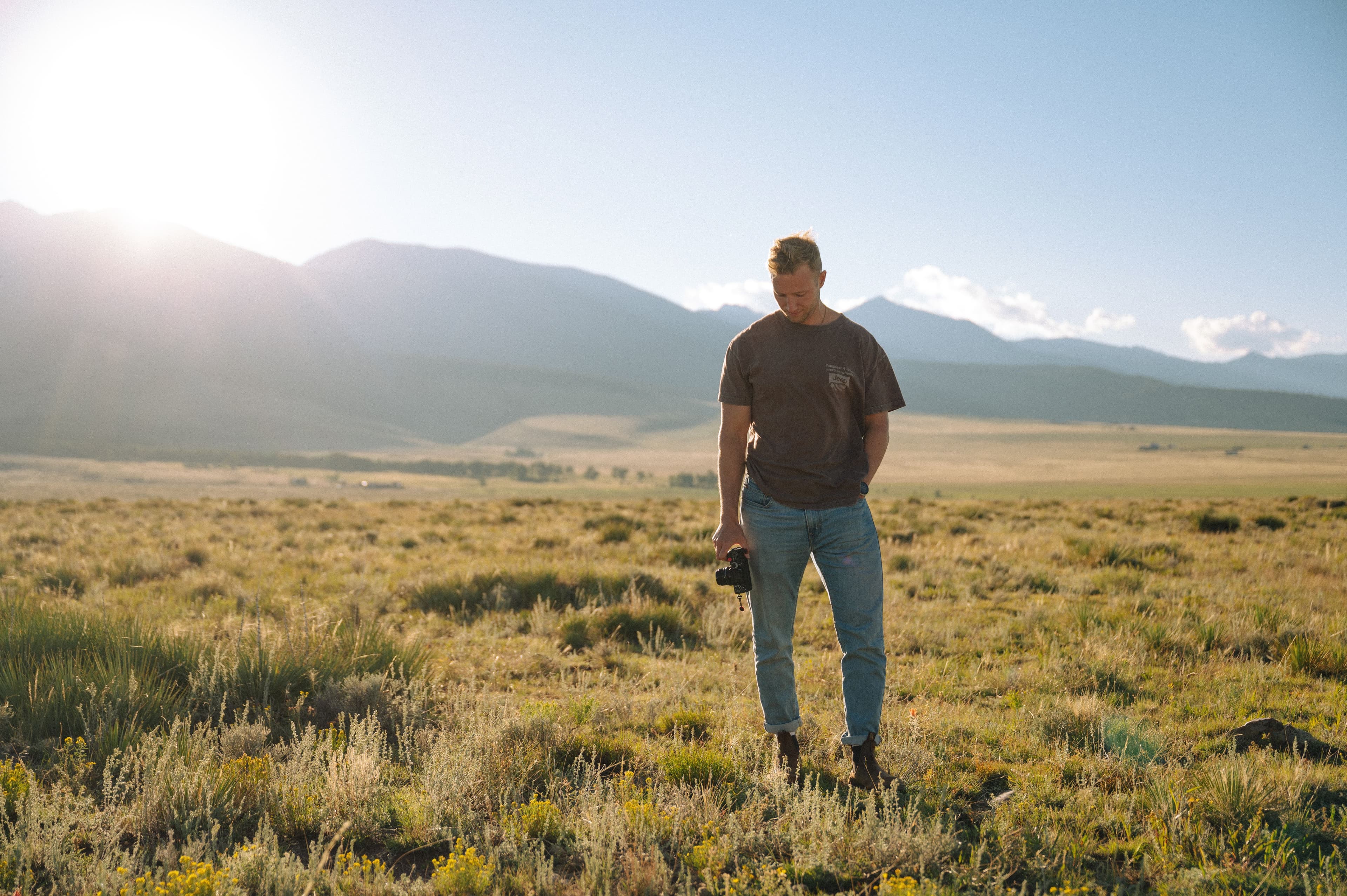 Kegan Sovay in the mountains holding a camera
