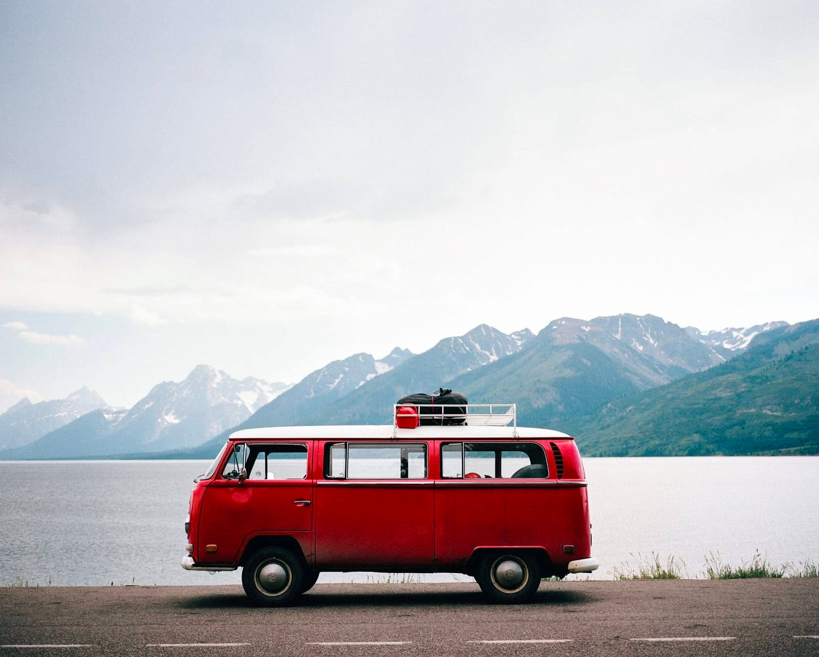 vintage van by lake and mountains