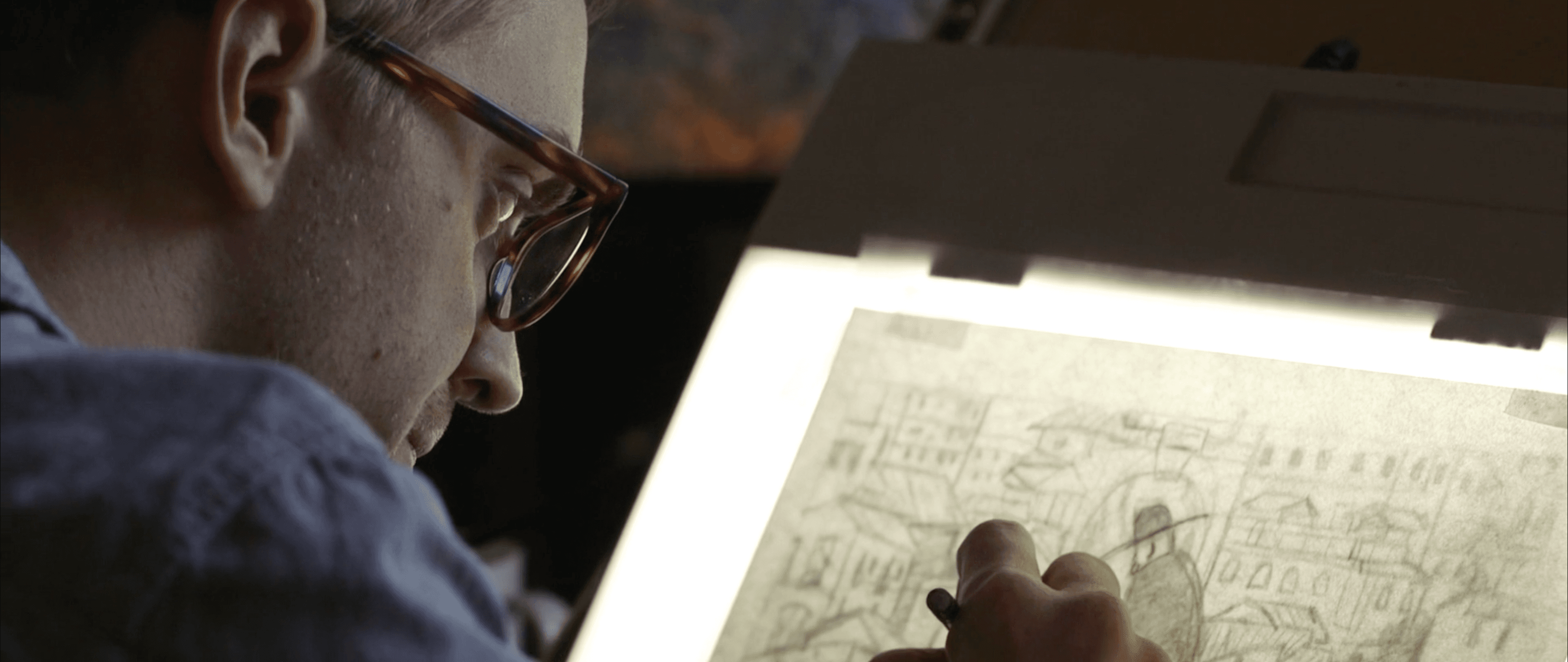 Jared Boggess drawing on a light table