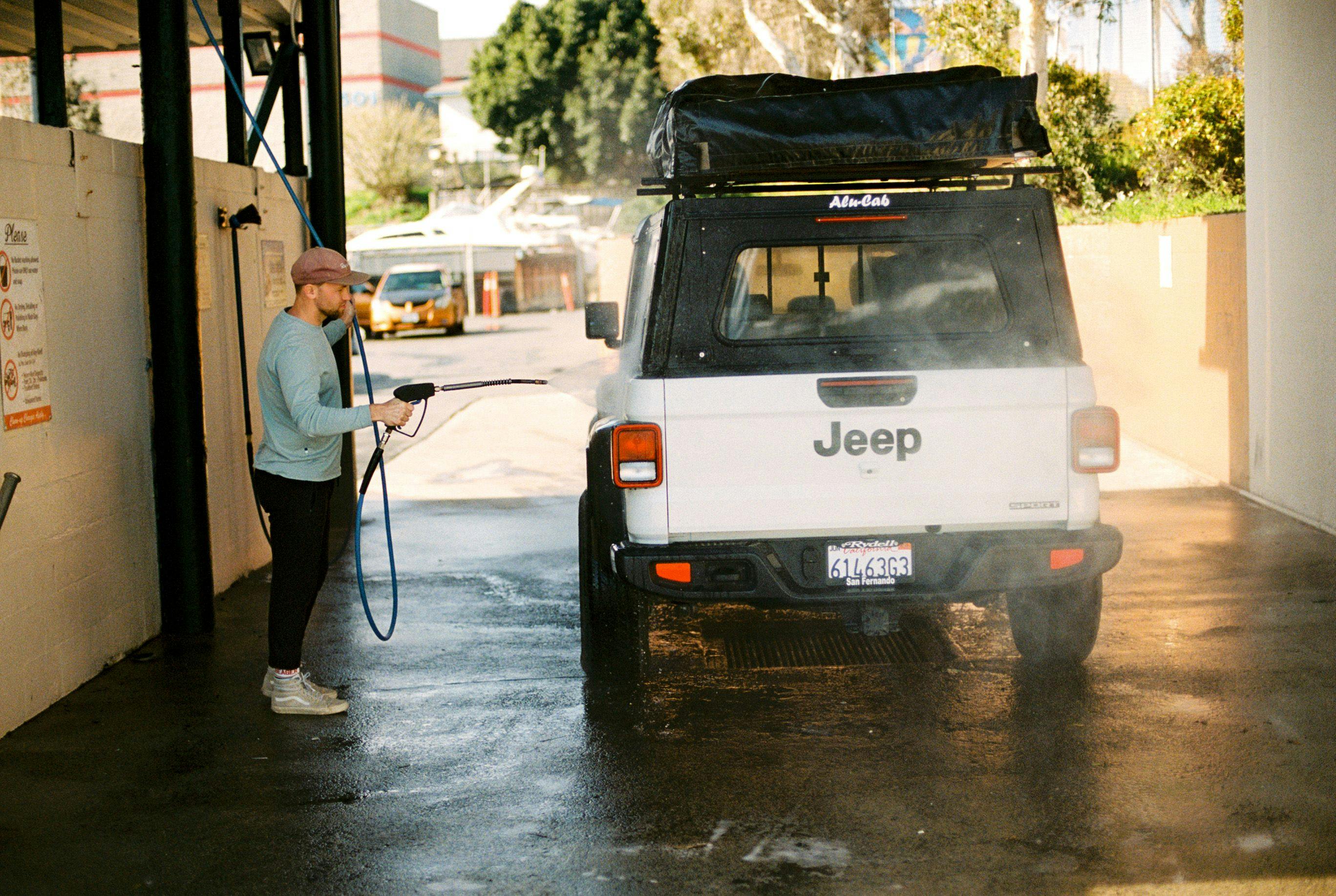 Tim Rhyne washing a Jeep